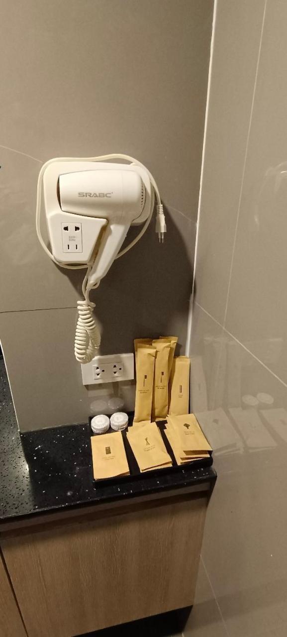 The Airport Courtyard Suvarnabhumi Airport Бангкок Экстерьер фото A hair dryer in a hotel bathroom