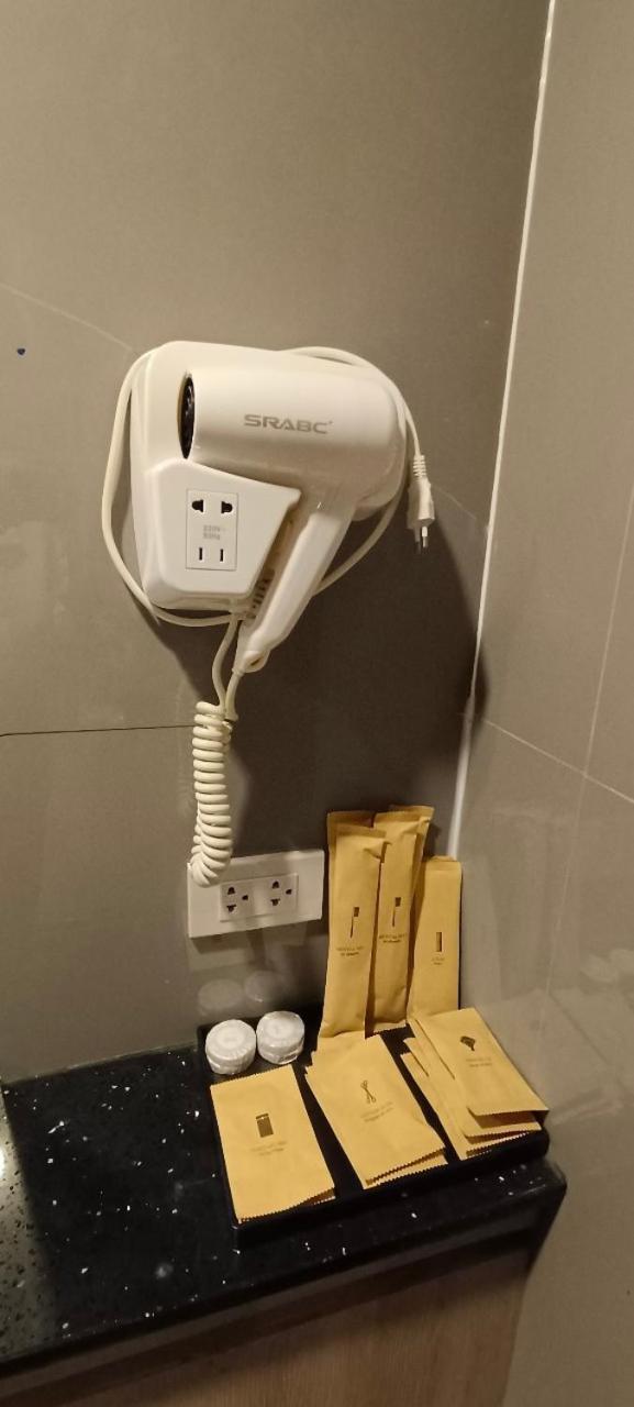 The Airport Courtyard Suvarnabhumi Airport Бангкок Экстерьер фото A hair dryer in a hotel bathroom